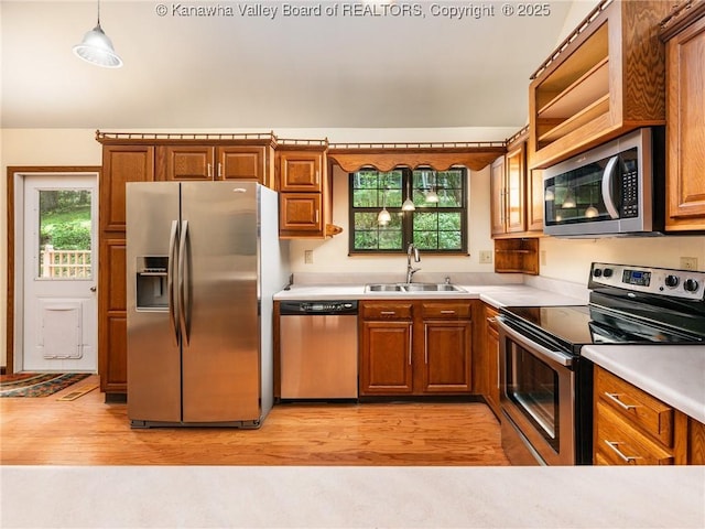 1799 Fishers Branch Rd, Charleston, WV 25312 - kitchen featuring stainless steel appliances, a sink, brown cabinets, light wood-style flooring, and light countertops