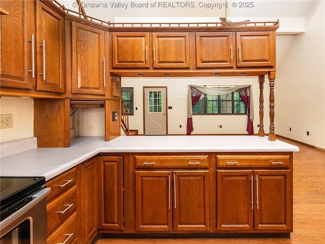 1799 Fishers Branch Rd, Charleston, WV 25312 - kitchen featuring brown cabinets, light countertops, a peninsula, and light wood finished floors