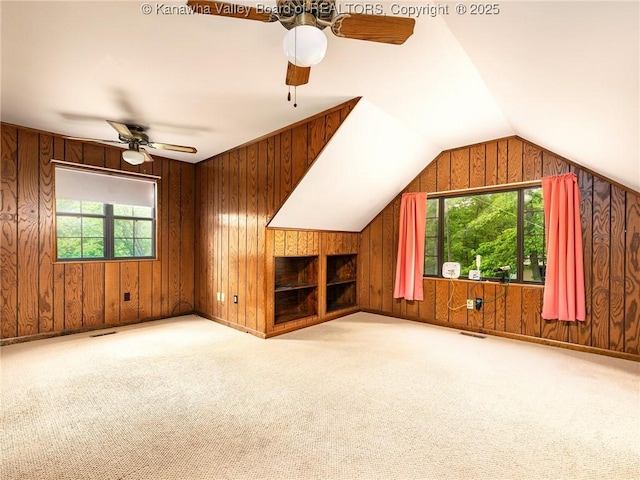 1799 Fishers Branch Rd, Charleston, WV 25312 - unfurnished living room with a ceiling fan, wooden walls, carpet flooring, and vaulted ceiling