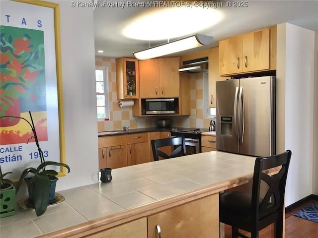 138 Woodbridge Dr, Charleston, WV 25311 - kitchen featuring appliances with stainless steel finishes, glass insert cabinets, tasteful backsplash, and tile countertops