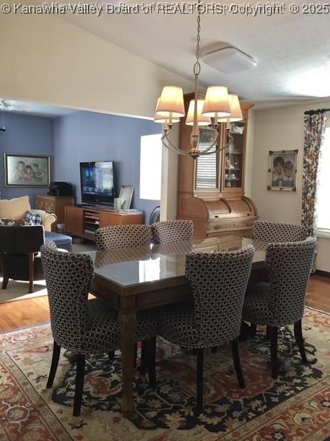 138 Woodbridge Dr, Charleston, WV 25311 - dining area featuring a chandelier, wood finished floors, and lofted ceiling