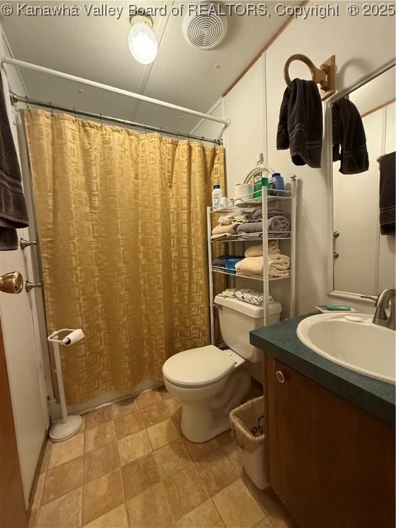 12 Brewster Dr, Chapmanville, WV 25508 - full bath with toilet, vanity, and a shower with shower curtain