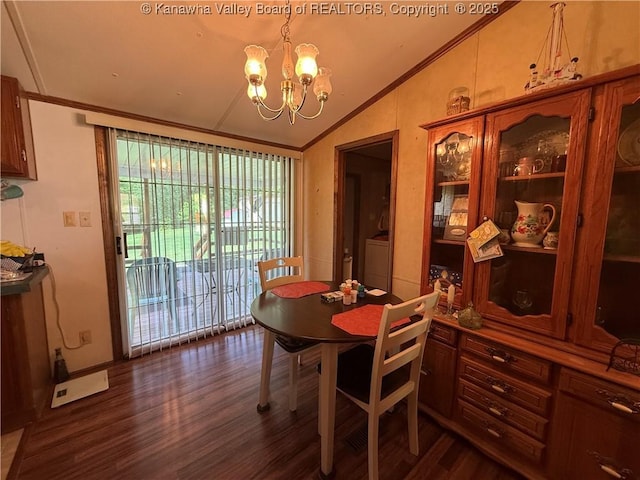 12 Brewster Dr, Chapmanville, WV 25508 - dining room with lofted ceiling, dark wood-type flooring, a chandelier, washing machine and clothes dryer, and ornamental molding