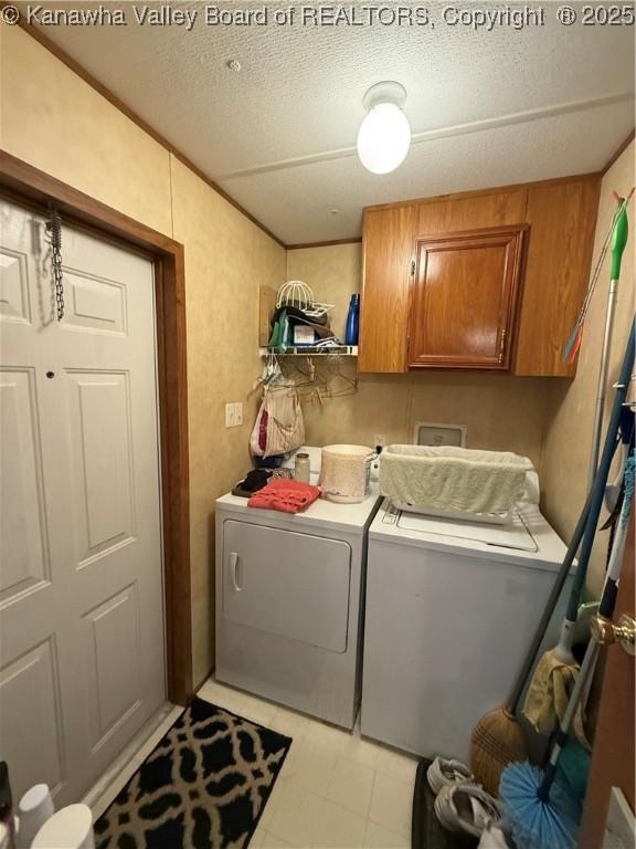 12 Brewster Dr, Chapmanville, WV 25508 - laundry room with washing machine and clothes dryer, cabinet space, and a textured ceiling
