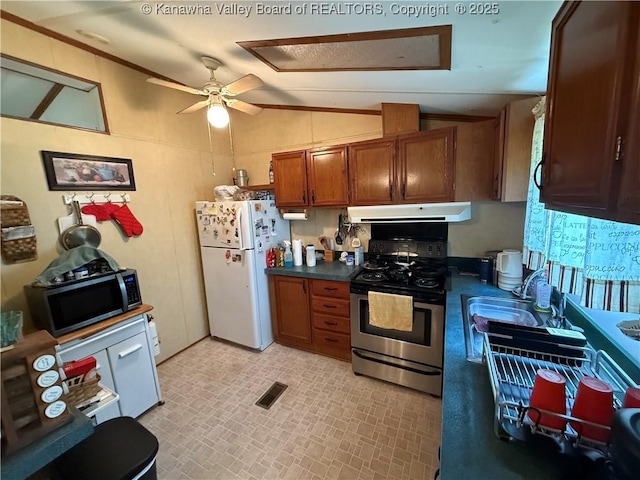 12 Brewster Dr, Chapmanville, WV 25508 - kitchen featuring stainless steel appliances, under cabinet range hood, lofted ceiling, dark countertops, and brown cabinetry