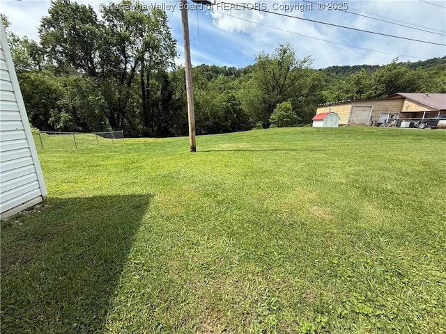 12 Brewster Dr, Chapmanville, WV 25508 - view of grassy yard featuring a garage