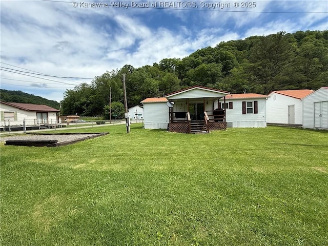 12 Brewster Dr, Chapmanville, WV 25508 - view of green lawn with a porch
