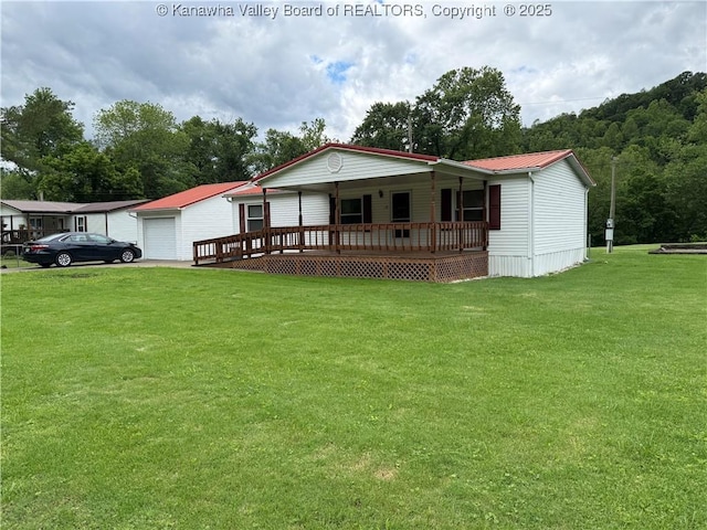 12 Brewster Dr, Chapmanville, WV 25508 - manufactured / mobile home featuring covered porch, a front lawn, metal roof, and a garage