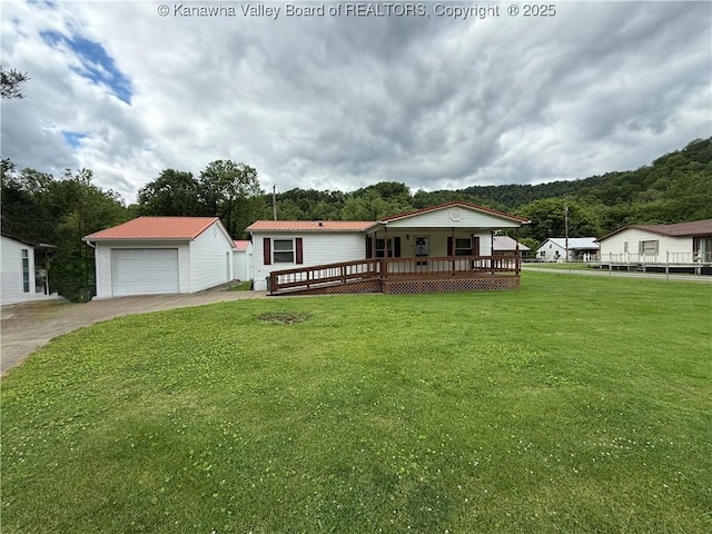 12 Brewster Dr, Chapmanville, WV 25508 - manufactured / mobile home with concrete driveway, a garage, an outdoor structure, metal roof, and a deck
