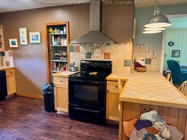 80 Flint Ln, Racine, WV 25165 - kitchen featuring black / electric stove, wall chimney exhaust hood, tile countertops, dark wood-style flooring, and decorative backsplash