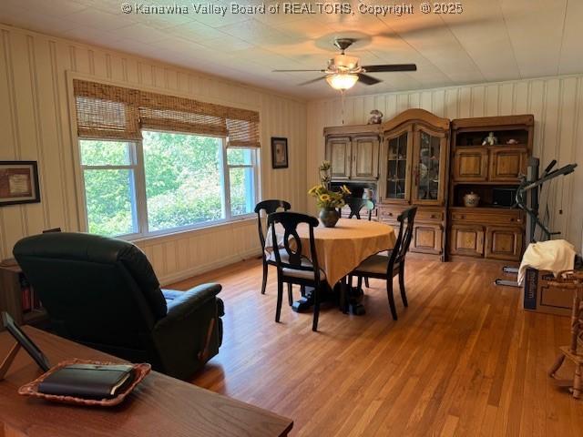 80 Flint Ln, Racine, WV 25165 - dining space featuring light wood-style flooring, ceiling fan, and wood walls