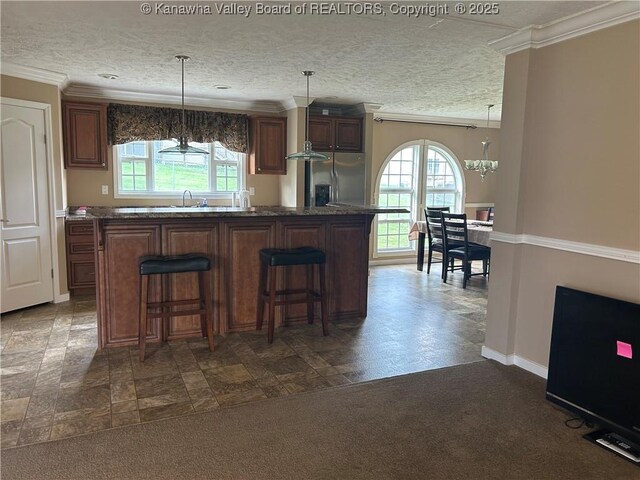 30 Beech Ln, Madison, WV 25130 - kitchen with stainless steel fridge, plenty of natural light, crown molding, a chandelier, and a kitchen bar