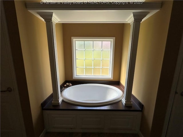 30 Beech Ln, Madison, WV 25130 - bathroom featuring a bath, ornate columns, and baseboards