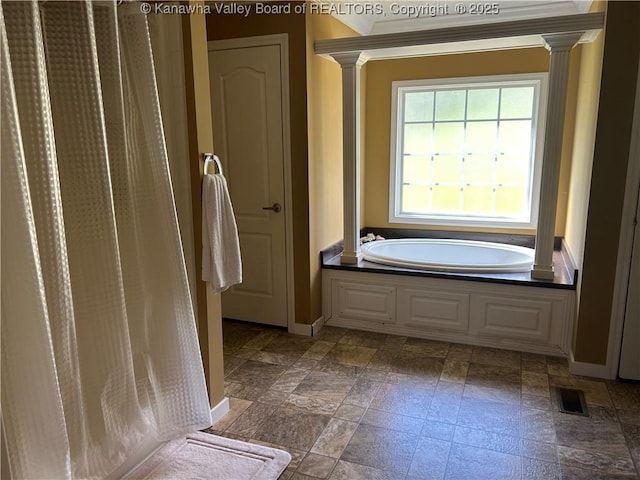 30 Beech Ln, Madison, WV 25130 - full bathroom with decorative columns, a garden tub, baseboards, and stone finish flooring