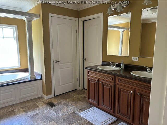 30 Beech Ln, Madison, WV 25130 - full bathroom with crown molding, double vanity, ornate columns, a bath, and stone finish floors