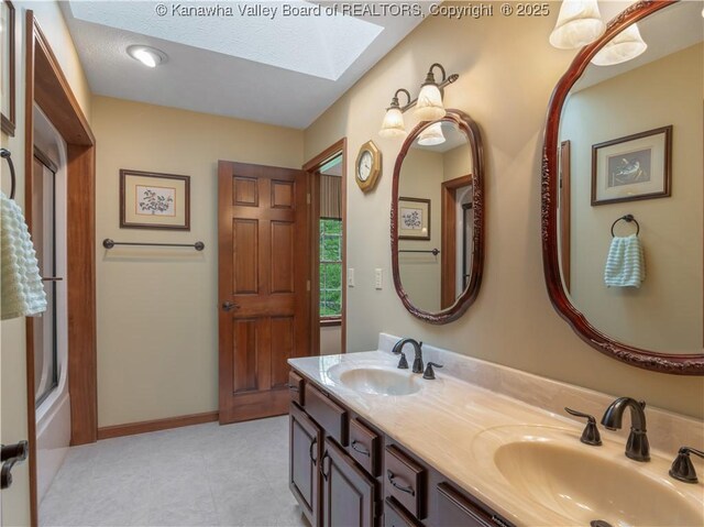 14 Woodclyffe Rd, Hurricane, WV 25526 - full bath with a skylight, double vanity, baseboards, a tub to relax in, and tile patterned floors