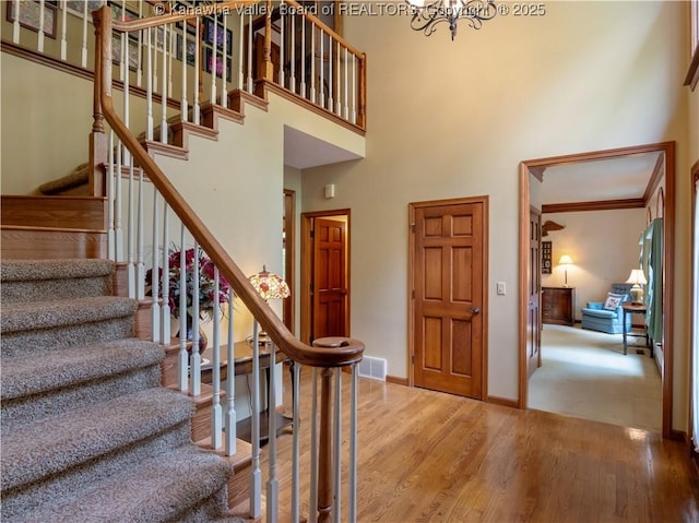 14 Woodclyffe Rd, Hurricane, WV 25526 - stairway featuring a high ceiling, wood finished floors, a chandelier, baseboards, and ornamental molding