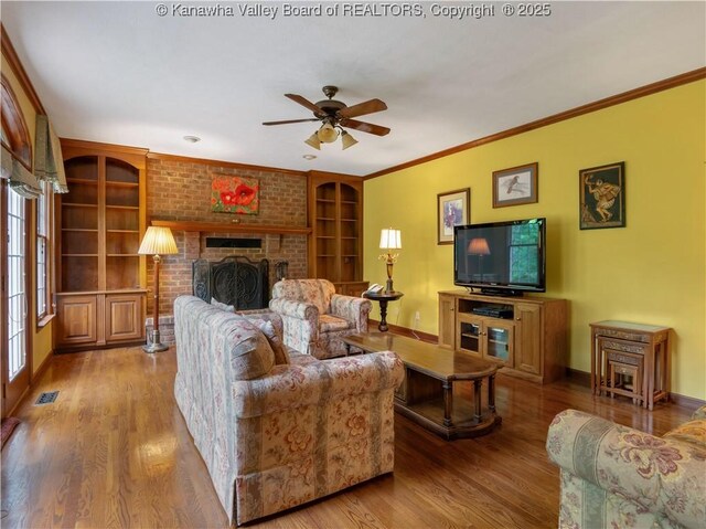 14 Woodclyffe Rd, Hurricane, WV 25526 - living area with baseboards, a ceiling fan, built in features, wood finished floors, and a fireplace