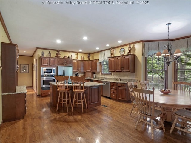 14 Woodclyffe Rd, Hurricane, WV 25526 - kitchen with appliances with stainless steel finishes, ornamental molding, a chandelier, a sink, and a center island