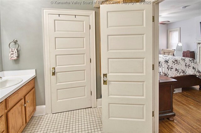 1313 Lee St E Unit 231, Charleston, WV 25301 - bathroom featuring vanity, ensuite bathroom, baseboards, and wood finished floors