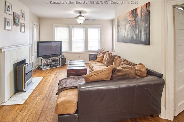1313 Lee St E Unit 231, Charleston, WV 25301 - living room with light wood-type flooring, ceiling fan, and a tile fireplace