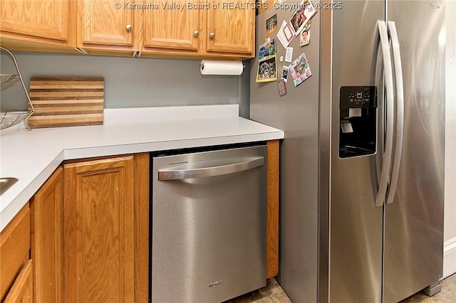1313 Lee St E Unit 231, Charleston, WV 25301 - kitchen with appliances with stainless steel finishes, light countertops, and brown cabinets