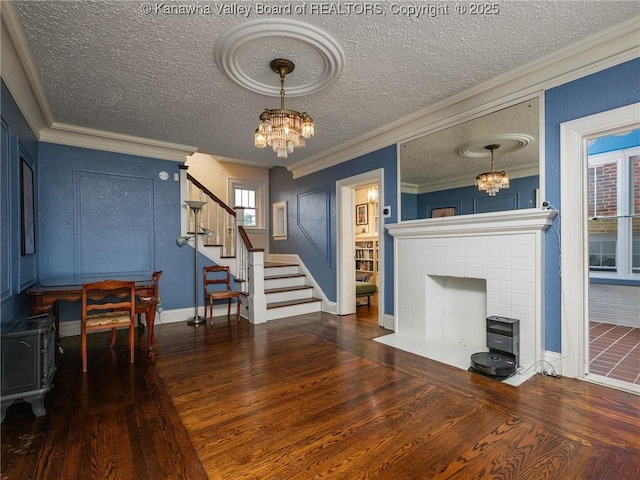 657 Beech Ave, Charleston, WV 25302 - living area featuring a chandelier, hardwood / wood-style floors, stairway, ornamental molding, and a textured ceiling