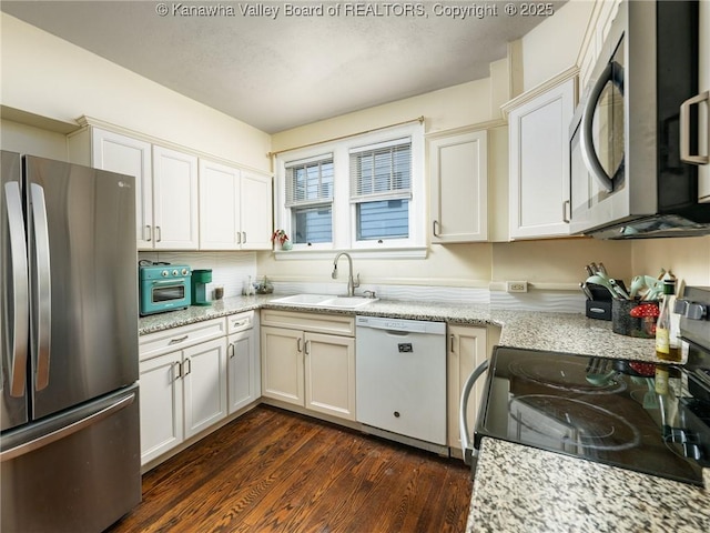 657 Beech Ave, Charleston, WV 25302 - kitchen featuring appliances with stainless steel finishes, a sink, dark wood-style flooring, white cabinetry, and light stone counters