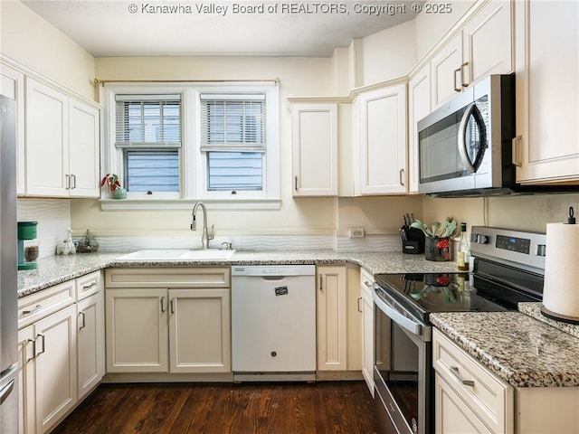 657 Beech Ave, Charleston, WV 25302 - kitchen featuring stainless steel appliances, a sink, dark wood-type flooring, and light stone counters