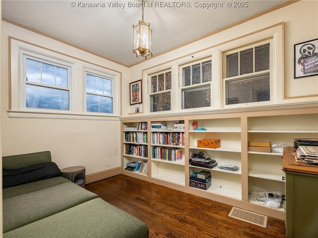 657 Beech Ave, Charleston, WV 25302 - sitting room with wood finished floors, crown molding, a chandelier, and baseboards