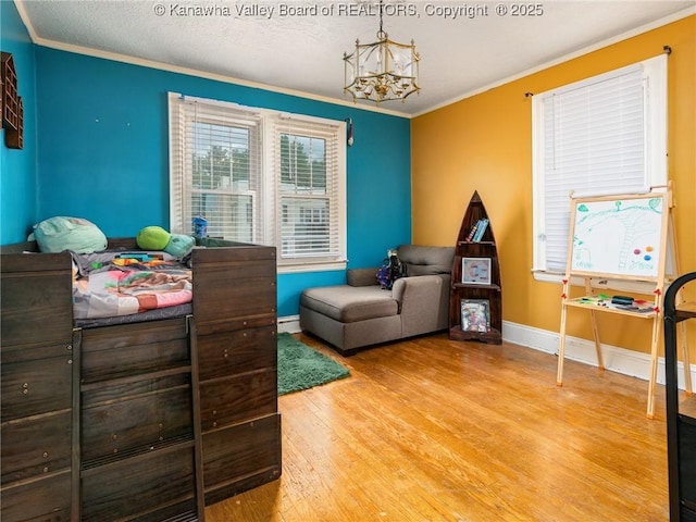 657 Beech Ave, Charleston, WV 25302 - bedroom featuring light wood-style floors, a chandelier, crown molding, baseboards, and a baseboard radiator