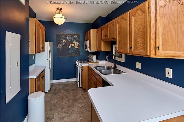 1313 Lee St E Unit 233, Charleston, WV 25301 - kitchen featuring range with gas cooktop, a sink, freestanding refrigerator, light countertops, and baseboards