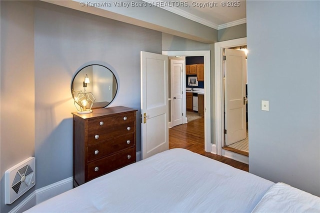 1313 Lee St E Unit 233, Charleston, WV 25301 - bedroom featuring ornamental molding, dark wood-type flooring, baseboards, and heating unit