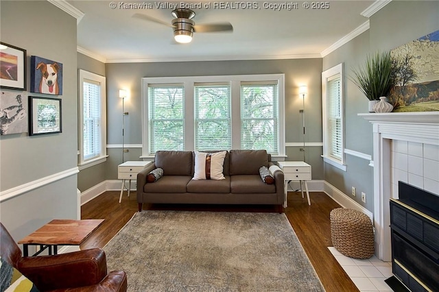 1313 Lee St E Unit 233, Charleston, WV 25301 - living room with wood finished floors, a tiled fireplace, a ceiling fan, crown molding, and baseboards