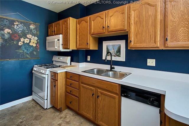 1313 Lee St E Unit 233, Charleston, WV 25301 - kitchen with white appliances, a sink, light countertops, baseboards, and brown cabinetry