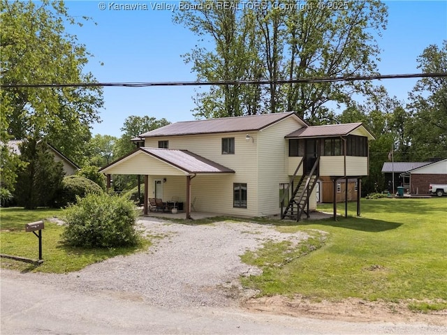 67 Poplar Dr, Scott Depot, WV 25560 - view of front of property with a sunroom, stairway, driveway, metal roof, and a front lawn