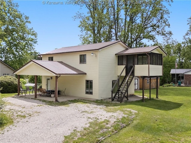 67 Poplar Dr, Scott Depot, WV 25560 - back of property featuring a sunroom, a patio area, stairs, and metal roof