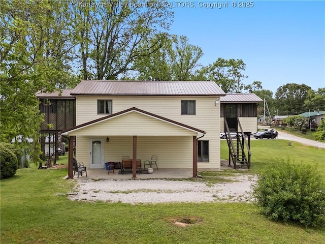 67 Poplar Dr, Scott Depot, WV 25560 - rear view of house featuring a patio, a yard, stairs, metal roof, and a sunroom
