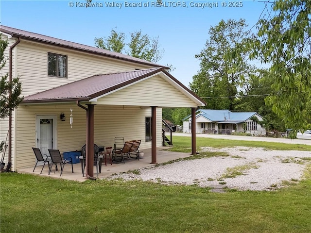 67 Poplar Dr, Scott Depot, WV 25560 - rear view of house with a patio area, a yard, and metal roof