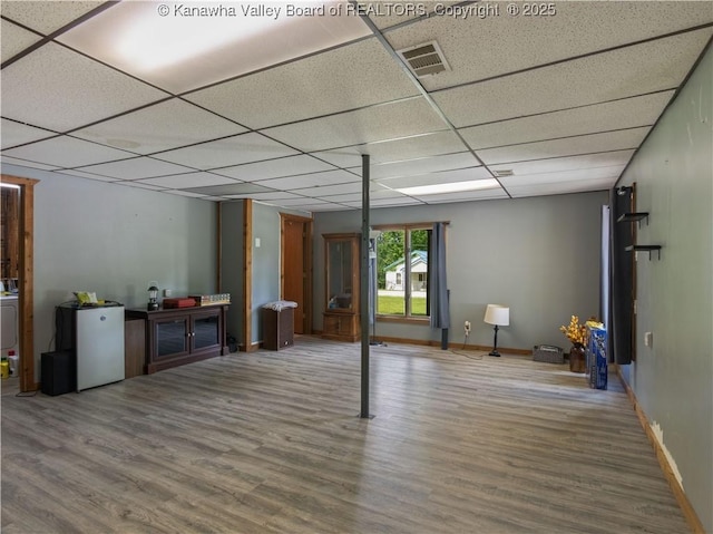 67 Poplar Dr, Scott Depot, WV 25560 - below grade area with wood finished floors, a drop ceiling, refrigerator, and baseboards