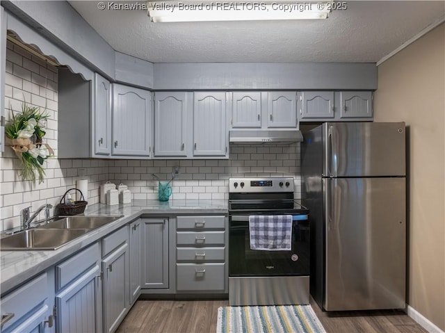 67 Poplar Dr, Scott Depot, WV 25560 - kitchen with stainless steel appliances, under cabinet range hood, a sink, wood finished floors, and a textured ceiling