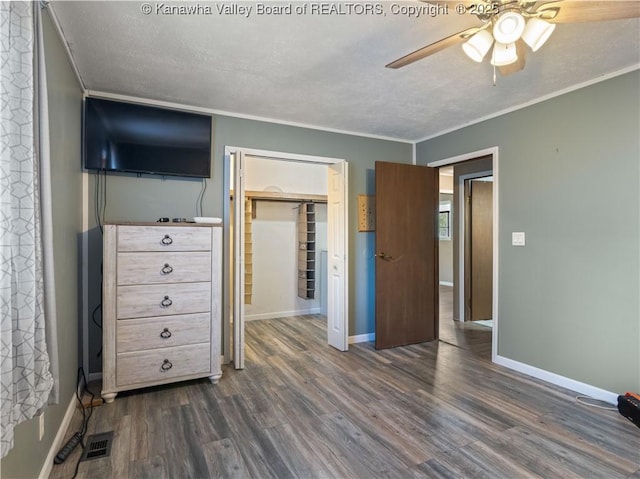 67 Poplar Dr, Scott Depot, WV 25560 - bedroom with dark wood-style flooring, a textured ceiling, baseboards, ornamental molding, and a closet