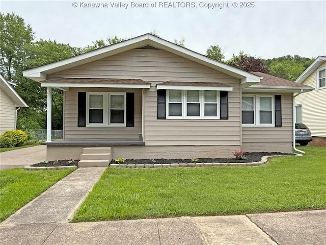 2111 21st St, Nitro, WV 25143 - bungalow with covered porch, a front yard, and a shingled roof