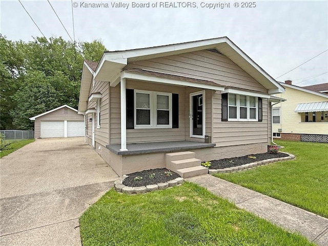 2111 21st St, Nitro, WV 25143 - bungalow-style house featuring a porch, a garage, an outbuilding, and a front lawn