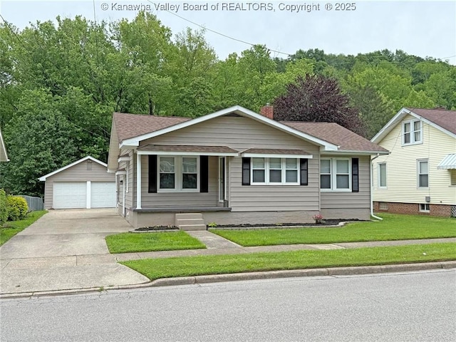 2111 21st St, Nitro, WV 25143 - view of front facade featuring a garage, an outdoor structure, a front yard, covered porch, and a shingled roof