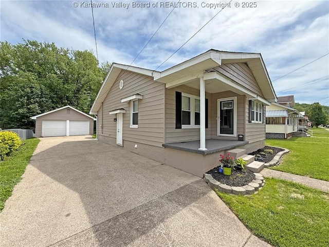 2111 21st St, Nitro, WV 25143 - view of front of property with covered porch, a garage, a front lawn, and an outdoor structure