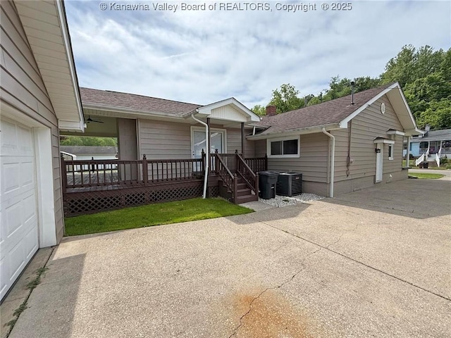 2111 21st St, Nitro, WV 25143 - view of front of property featuring central AC unit, roof with shingles, and concrete driveway