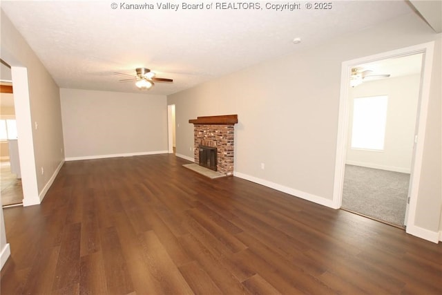 2111 21st St, Nitro, WV 25143 - unfurnished living room featuring a ceiling fan, dark wood-style floors, a brick fireplace, and baseboards