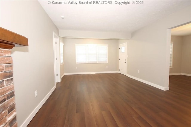 2111 21st St, Nitro, WV 25143 - unfurnished living room featuring dark wood finished floors and baseboards