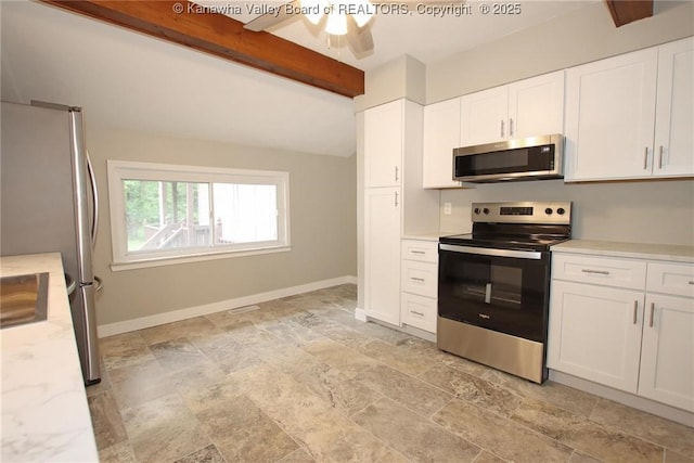 2111 21st St, Nitro, WV 25143 - kitchen featuring stainless steel appliances, stone finish floors, white cabinetry, beam ceiling, and baseboards